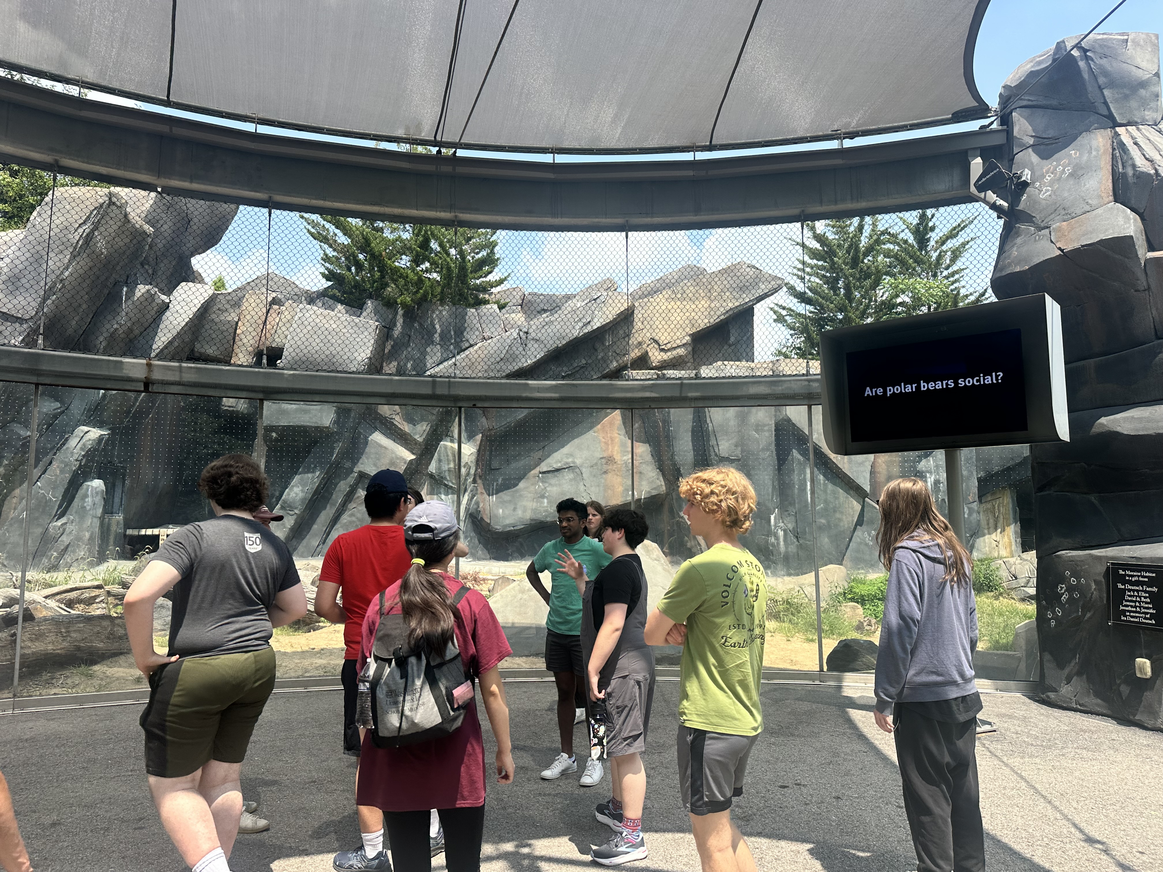 a group of people at a zoo