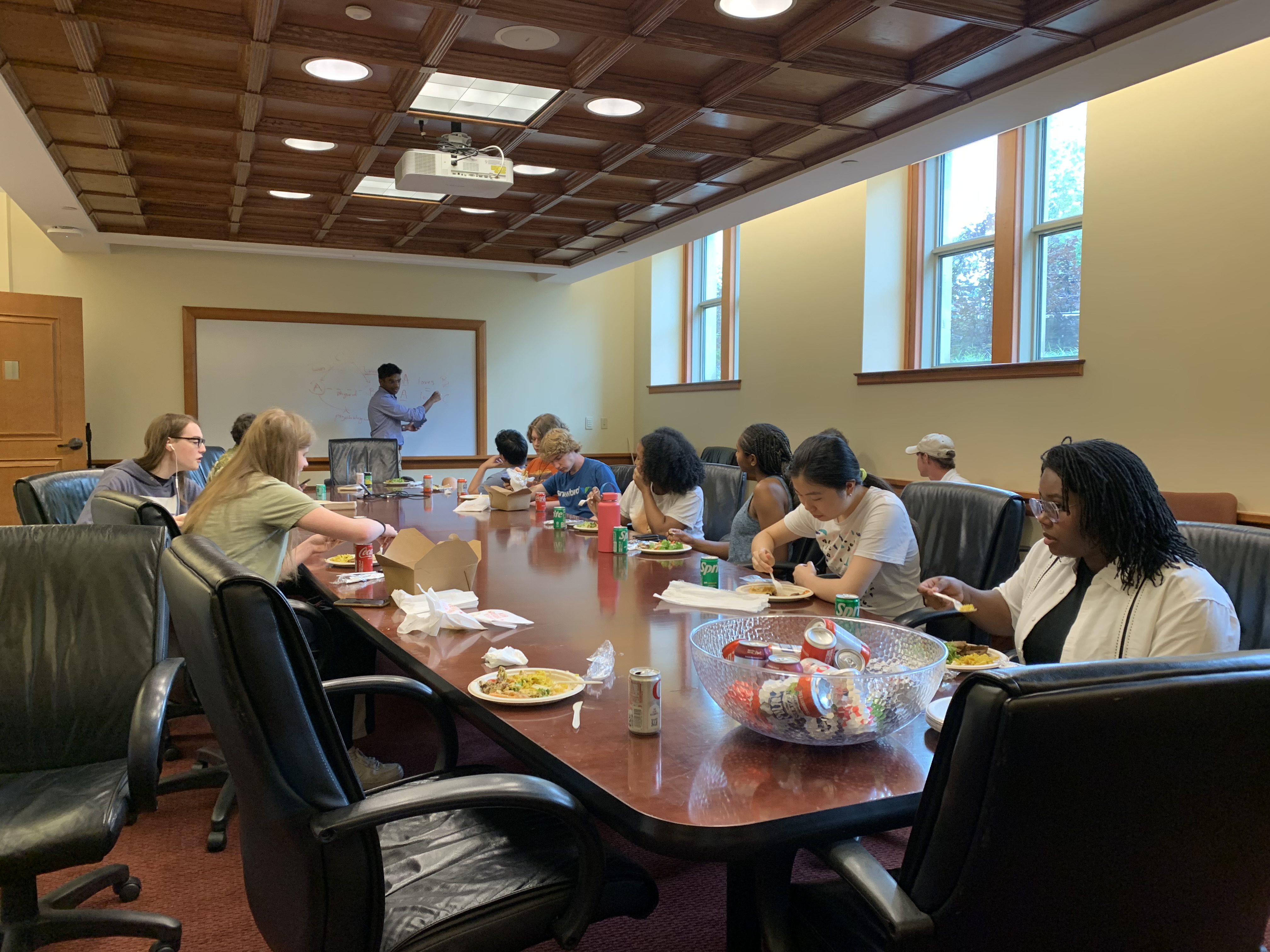 people in a conference room eating lunch