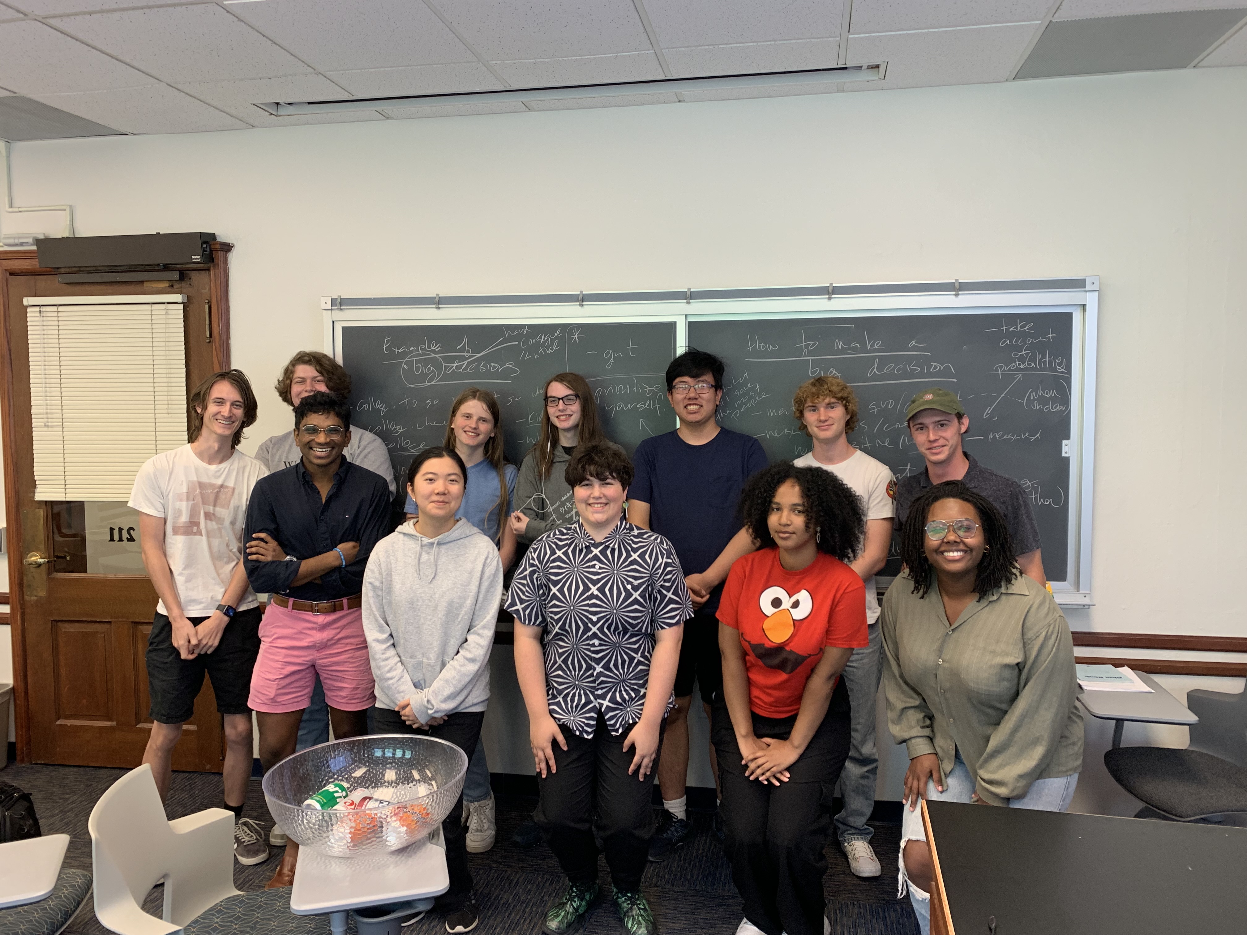 a group of students posing for a photo in a classroom