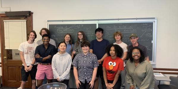 a group of students posing for a photo in a classroom