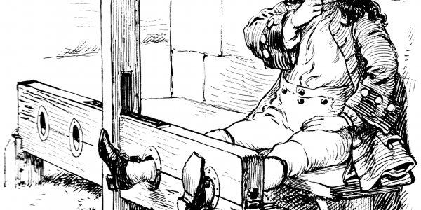 a man with his feet in the stocks